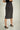 Magasinez la jupe portefeuille brillante de Colori - Shop the shiny wrap skirt from Colori