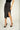 Magasinez la jupe portefeuille brillante de Colori - Shop the shiny wrap skirt from Colori