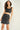 Magasinez la jupe courte en faux cuir de Colori - Shop the faux leather short skirt from Colori